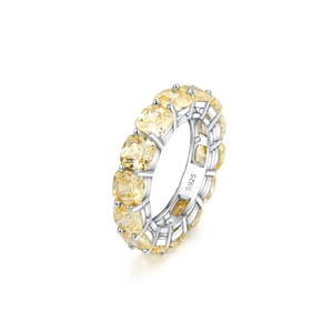 Detailed macro view of S925 sterling silver eternity ring with yellow cushion-cut stones