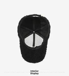 Detail of the six-panel interior lining and reinforced tape on a black fleece cap