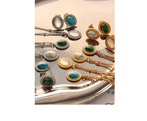 Macro detail of bohemian jewelry set featuring turquoise and opal stones on metal tray