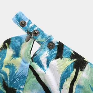 Detail of tropical palm print twill fabric and three metal snap button closures