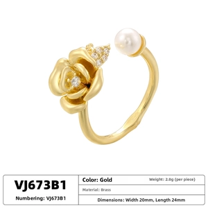 Detailed macro view of gold-plated rose ring with zircon petals and a white pearl accent