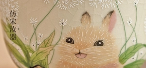 Detail of Ru Kiln porcelain tea cup with hand-painted rabbit and ice-crack glaze finish