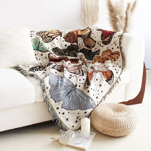 Detailed texture of bohemian knit blanket with colorful butterflies and tassels