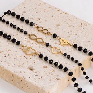 Black beaded heart bracelet with gold infinity symbol and heartbeat charms on stone
