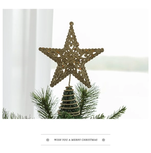 Close-up of golden hollow star tree topper with glitter finish for Christmas tree