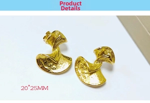 Detail of 18K gold-plated stainless steel fan earrings with textured hammer finish