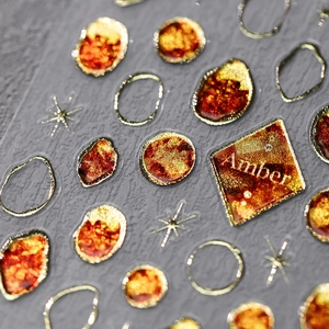 Amber and gold foil nail art stickers with resin stone and metallic star design