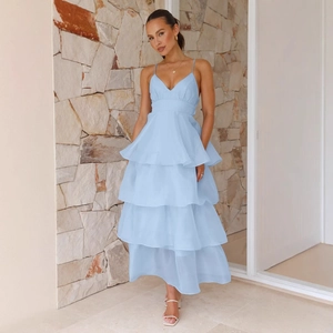 Elegant light blue backless tiered maxi dress with thin straps and ruffled hem design