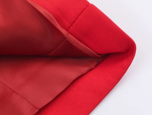 Detail of red fabric texture with premium double-layered lining and quality stitching