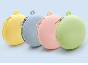 Close-up of four macaron-colored silicone coin purses with zippers and hanging loops
