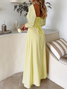 Detail of elegant yellow evening dress featuring a stylish back lace-up design