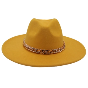 Detail of yellow wool fedora hat with a bold gold acrylic chain and wide brim