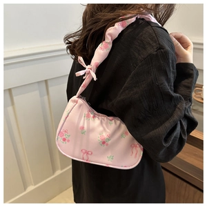 Pink underarm bag with rose flower and ribbon pattern featuring pleated shoulder straps