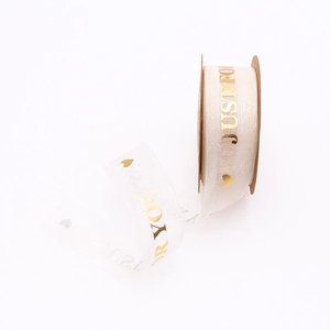 Detail of white organza ribbon with gold 'Just For You' lettering and heart patterns