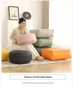 Detail view of colorful round floor cushions with side handles and textured fabric