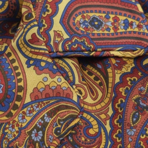 Macro detail of high-quality paisley print fabric showing twill weave and fiber texture