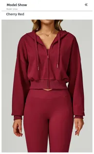 Detail of cherry red hoodie with drawstring and high-waist leggings featuring cross waist