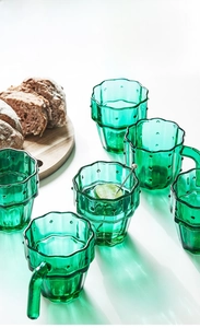Detail of green cactus glass cup with textured non-slip surface and creative plant handle