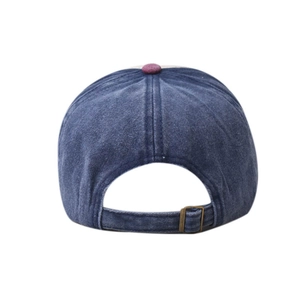 Detail view of washed denim baseball cap back with purple button and metal strap