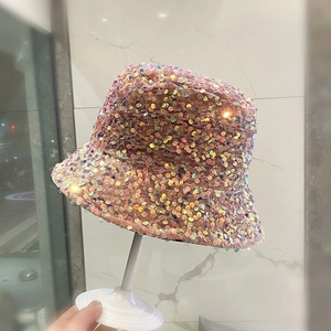 Detail of pink sequins on a bucket hat with sparkling light reflections and textured finish