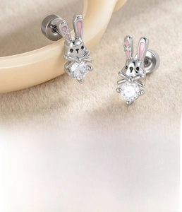 Detailed macro view of pink enamel bunny earrings with round zircon inlay in silver finish