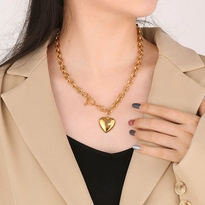 Close-up of a chunky gold stainless steel chain necklace with 3D heart pendant and OT clasp