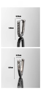 Detailed view of vintage silver V-shaped earrings with rope texture and smiley engravings