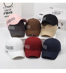 Close-up of vintage baseball caps featuring side embroidery and distressed brim details