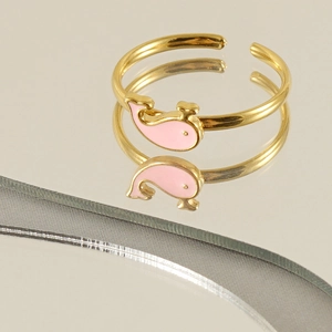 Golden open ring featuring a pink enamel whale design with a mirror reflection effect