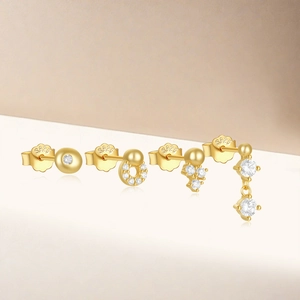 Detailed set of four gold S925 sterling silver stud earrings with sparkling zircons