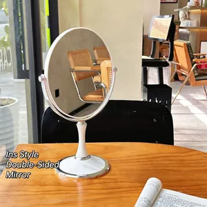 Rotating round double-sided desktop vanity mirror with white base and chrome frame