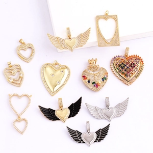 Macro view of gold and silver plated heart pendants with zircon micro-pave detailing