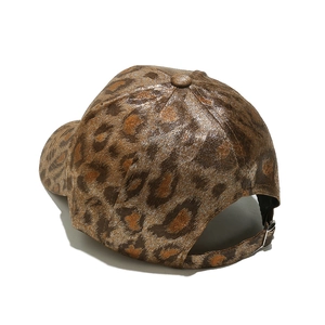 Detail of leopard print baseball cap featuring metallic finish and metal rear buckle