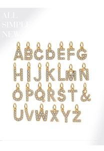 Detailed grid of 26 gold-plated letter pendants set with shimmering cubic zirconia