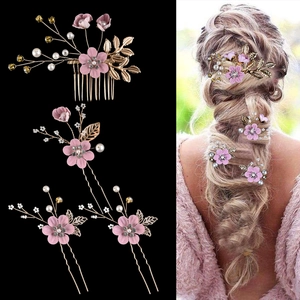 Detail of pink bridal hair comb set with fabric flowers and pearls on model