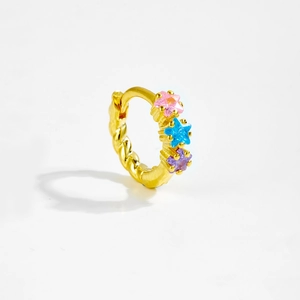 Detail of a gold hoop earring with rope texture and three colorful star-shaped stones