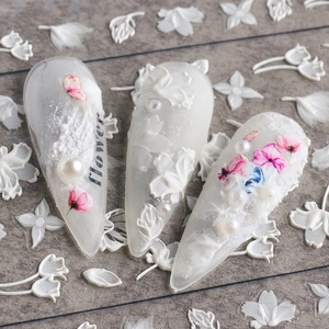 Macro shot of 5D white lace flower nail stickers with pink accents and pearls