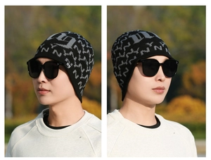 Detailed view of men's fleece-lined knit beanie with gray NY pattern and stylish sunglasses