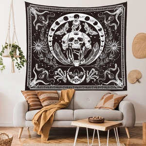 Detail of gothic moth and skeleton tapestry hanging above a modern living room sofa