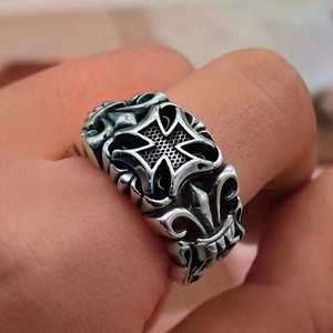 Close-up of gothic cross and iris embossing on vintage silver finish trident ring