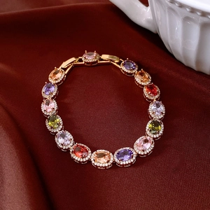 Macro detail of vintage gold bracelet with multi-colored oval zircon gemstones