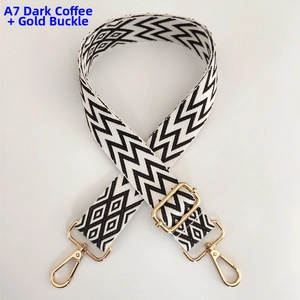 Close-up of dark coffee wave pattern woven strap with adjustable gold metal buckle
