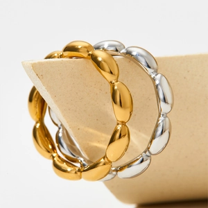 Polished stainless steel rings in gold and silver with minimalist beaded wave texture