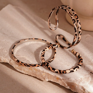 Vintage leopard print double-layer open bangle set on a natural stone display