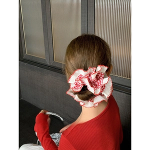 French style red checkered scrunchie with white lace edges shown on a ponytail