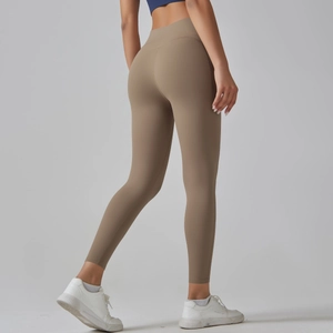 Detail view of high-waist coffee yoga leggings with push-up effect and seamless texture