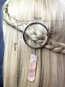 Detail of 6cm silver circle hair clip with pink crystal pendant on braided blonde hair