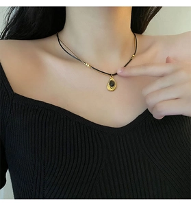 Close-up of vintage double-layer teardrop pendant necklace on model with tiger eye stone
