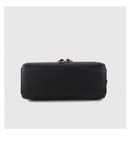 Detail view of the black lychee pattern leather base with stitching and gold metal rings