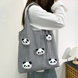 Detail of checkered canvas tote bag with 3D panda plush toys and spacious interior